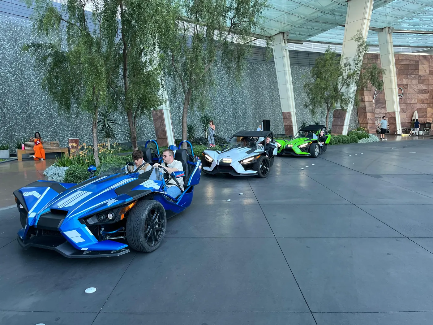 Blue Polaris Slingshot under a hotel portico